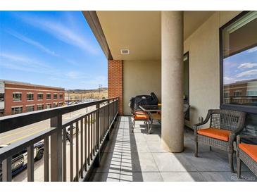 Spacious balcony with a view of the city, comfortable seating, and a grill for outdoor cooking at 20 Wilcox St # 208, Castle Rock, CO 80104