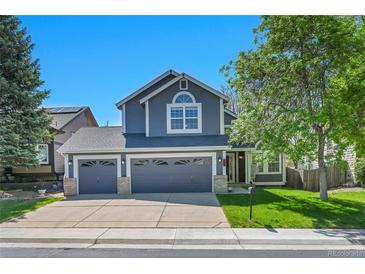 Charming two-story home with a three car garage and landscaped front yard at 9008 W 101St Ave, Broomfield, CO 80021