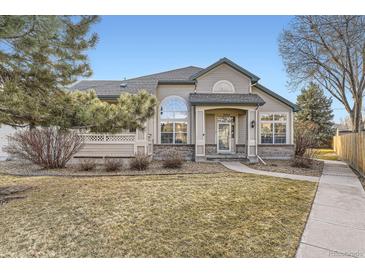 Charming home with well-manicured lawn and welcoming front porch, perfect for relaxing outdoors at 9742 E Hawaii Pl, Aurora, CO 80247