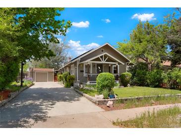 Charming home with mature trees, detached garage, and well-maintained front yard at 4779 S Bannock St, Englewood, CO 80110