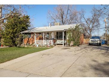 Charming brick home features a covered front porch and long driveway at 3778 S Hooker St, Englewood, CO 80110
