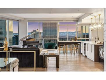 Bright and airy living room with floor-to-ceiling windows offering panoramic city views and mountain views at 2001 Lincoln St # 2923, Denver, CO 80202