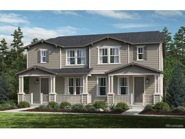Charming townhome with a covered front porch and well-maintained landscaping at 28636 E 6Th Pl, Watkins, CO 80137