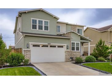 Charming two-story home features a two-car garage and well-manicured lawn at 6883 E 132Nd Pl, Thornton, CO 80602