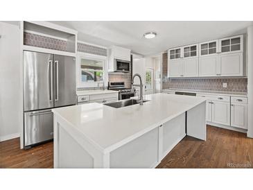 Bright kitchen features a large island, stainless steel appliances, and stylish backsplash at 741 S 6Th Ave, Brighton, CO 80601