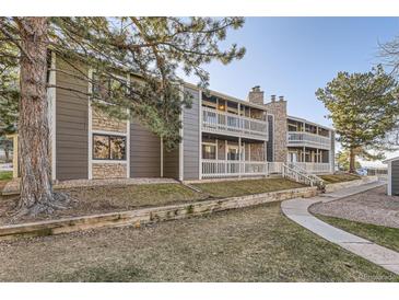 Charming condo featuring stone accents, private balconies, and mature trees at 18043 E Ohio Ave # 202, Aurora, CO 80017