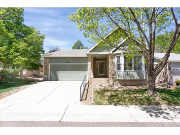 Charming single-story home with well-maintained lawn and attached two-car garage at 8951 Greenwich St, Highlands Ranch, CO 80130