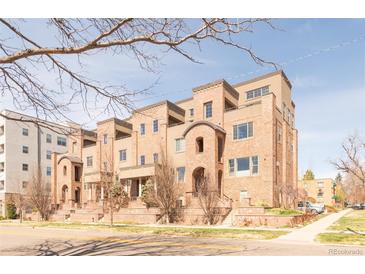 Elegant brick townhouse complex featuring arched entryways and private terraces offers a sophisticated urban living experience at 2397 E Iliff Ave, Denver, CO 80210
