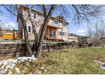 Charming two-story home with a welcoming front porch and well-maintained yard at 16 Prairie St, Palmer Lake, CO 80133