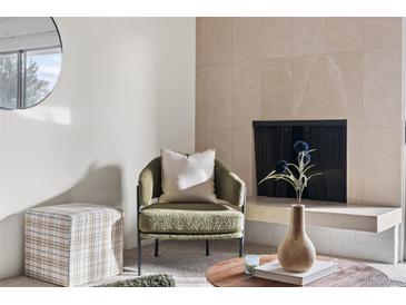 Bright living room with fireplace, and sliding glass door to balcony at 1313 N Williams St # 703, Denver, CO 80218