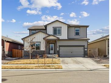 Charming two-story home with neutral paint, stone accents, and a spacious two-car garage at 8852 Ventura St, Commerce City, CO 80022