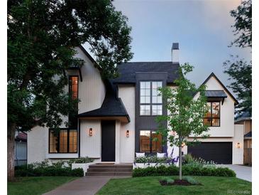 Striking two-story home featuring a modern design with a manicured lawn and beautiful landscaping at 346 Elm St, Denver, CO 80220