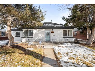 Charming ranch home with a well-manicured lawn and walkway at 2610 Poplar St, Denver, CO 80207