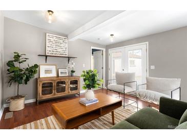 Bright living room featuring hard wood floors, stylish furniture, and a neutral color palette at 2610 Poplar St, Denver, CO 80207