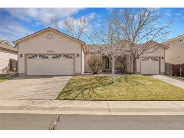 Charming single-story home featuring a two-car garage and well-maintained front yard at 20630 E Ithaca Pl, Aurora, CO 80013