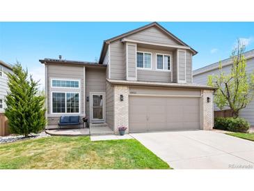 Charming two-story home with a well-maintained front yard, attached two-car garage and covered front porch at 10512 Hyacinth St, Highlands Ranch, CO 80129