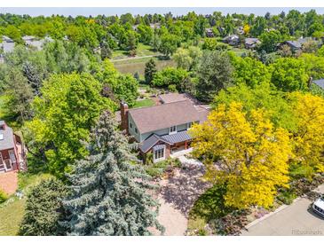 Overhead view of home featuring mature trees and well manicured front yard landscaping with fresh green grass at 1579 W Costilla Pl, Littleton, CO 80120