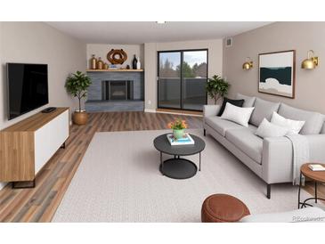 Bright living room features a fireplace, balcony access, and modern decor for a comfortable and stylish space at 7255 E Quincy Ave # 205, Denver, CO 80237