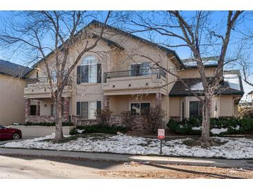 Two-story townhome with a brick facade and balcony at 8671 E Dry Creek Rd # 721, Englewood, CO 80112