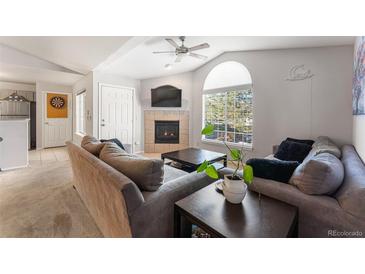 Cozy living room features a fireplace and plenty of natural light at 8671 E Dry Creek Rd # 721, Englewood, CO 80112