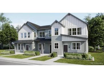 Charming two-story townhome with a modern farmhouse facade, lush landscaping, and inviting curb appeal at 6639 Parterre N Pkwy # 3, Thornton, CO 80602