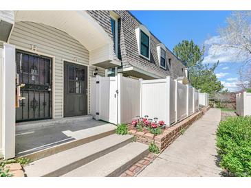 Charming home exterior featuring a well-maintained walkway and a quaint, fenced-in front yard at 1350 S Idalia St # G, Aurora, CO 80017