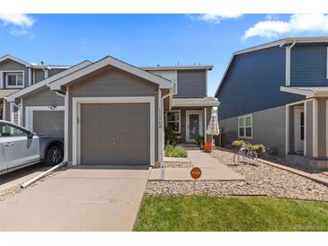 Charming two-story home with a well-maintained lawn, a driveway, and a one car garage at 11062 Gaylord St, Northglenn, CO 80233