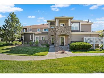 Charming townhome with a well-maintained lawn and stone accents on the facade, perfect for curb appeal at 6202 Kilmer Loop # 202, Golden, CO 80403