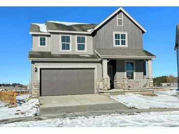 Charming two-story home featuring a spacious two-car garage and a welcoming front porch, perfect for enjoying the outdoors at 201 Paloma Way, Elizabeth, CO 80107