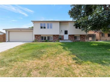 Charming two-story home with a well-maintained lawn and traditional architectural details on a sunny day at 6994 W Hinsdale Dr, Littleton, CO 80128