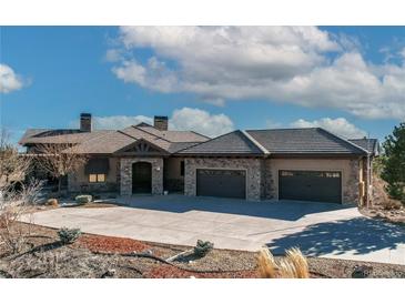 Stunning home featuring a tile roof, stone accents, and a spacious three-car garage at 4691 Bandera Pl, Parker, CO 80134