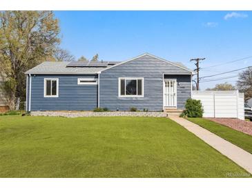 Charming home with a well-manicured lawn, modern siding, solar panels, and a welcoming walkway leading to the front door at 1498 S Perry St, Denver, CO 80219
