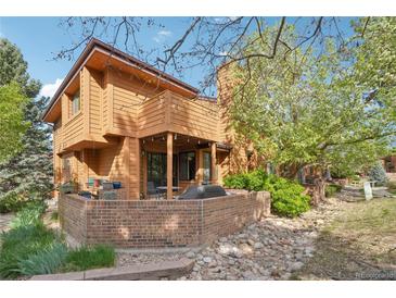 Exterior view of home featuring a brick patio and beautiful landscaping at 9400 E Iliff Ave # 181, Denver, CO 80231