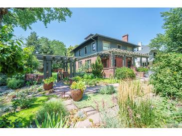 Beautiful two-story home boasts professionally landscaped yard, pergola, brickwork and lush greenery at 171 N Franklin St, Denver, CO 80218