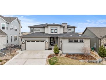 Beautiful home with a two-car garage, neutral exterior, and well-maintained landscaping at 7077 Copper Sky Cir, Castle Pines, CO 80108