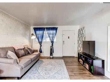 Comfortable living room with neutral paint, modern decor, and wood-look floors at 6800 E Tennessee Ave # 461, Denver, CO 80224