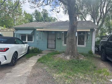 Charming bungalow-style home with a large tree in the front yard at 260 Sheridan Blvd, Denver, CO 80226