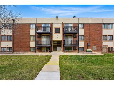 Two-story brick apartment building with black iron balconies, walkway, and green lawn at 5995 W Hampden Ave # 3I, Denver, CO 80227