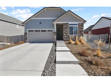 Charming home with a two-car garage, stone accents, and a well-maintained front yard at 4478 Riviera Ct, Aurora, CO 80019