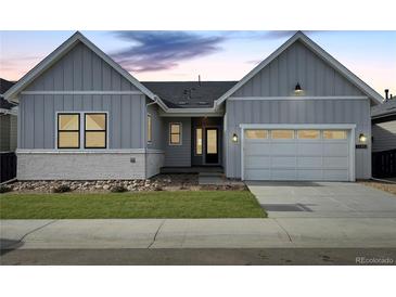 Charming home with a two-car garage, well-maintained lawn and attractive stone accents at 11453 Autumn Moon St, Littleton, CO 80125