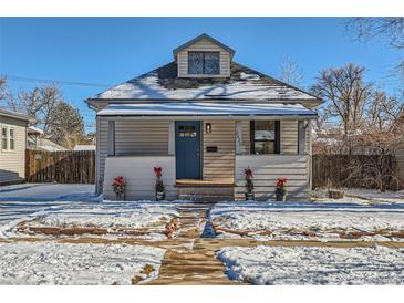 Charming bungalow with a newly renovated exterior and snowy front yard at 2222 Fenton St, Edgewater, CO 80214