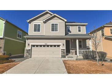 Charming two-story home featuring a two-car garage, covered entry, and neutral-colored siding under a clear blue sky at 3565 E 141St Dr, Thornton, CO 80602