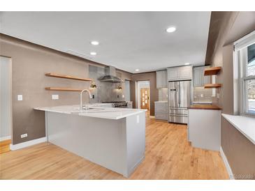 Updated kitchen with gray cabinets and quartz countertops at 749 Poplar St, Denver, CO 80220