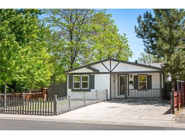 Charming home featuring gray and white exterior paint, well-maintained landscaping, and a fenced yard at 1522 Willow St, Denver, CO 80220