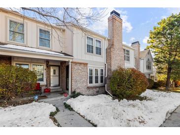 Brick townhouse exterior with snow-covered landscaping and a walkway at 18234 E Arizona Ave # E, Aurora, CO 80017