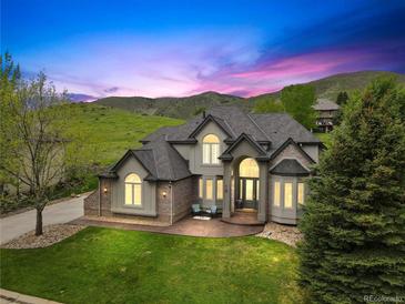 Stunning two-story home with lush front lawn, manicured landscaping, and mountain views at 10 Summit Ash, Littleton, CO 80127