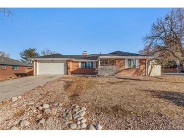 Brick ranch home with a landscaped yard at 406 Titan Ct, Aurora, CO 80011