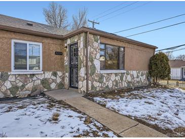 House exterior featuring stone accents and a well-maintained front yard at 3259 N Adams St, Denver, CO 80205