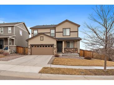 Two-story home showcasing a manicured lawn, complemented by a two-car garage and appealing modern architecture at 9608 Albion Ln, Thornton, CO 80229