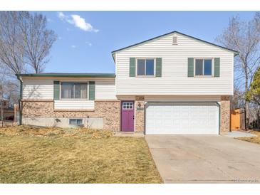 Charming two-story home featuring a purple front door, brick accents, and an attached two-car garage at 1812 24Th Ave, Longmont, CO 80501